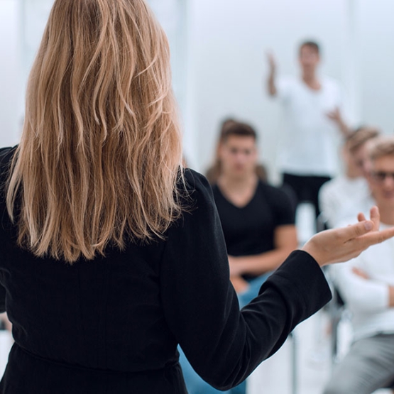 background image of a business seminar in a bright conference room