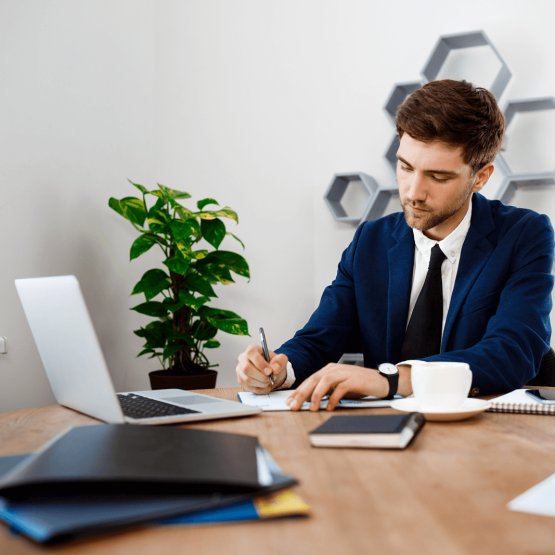 young-successful-businessman-sitting-workplace-office-background